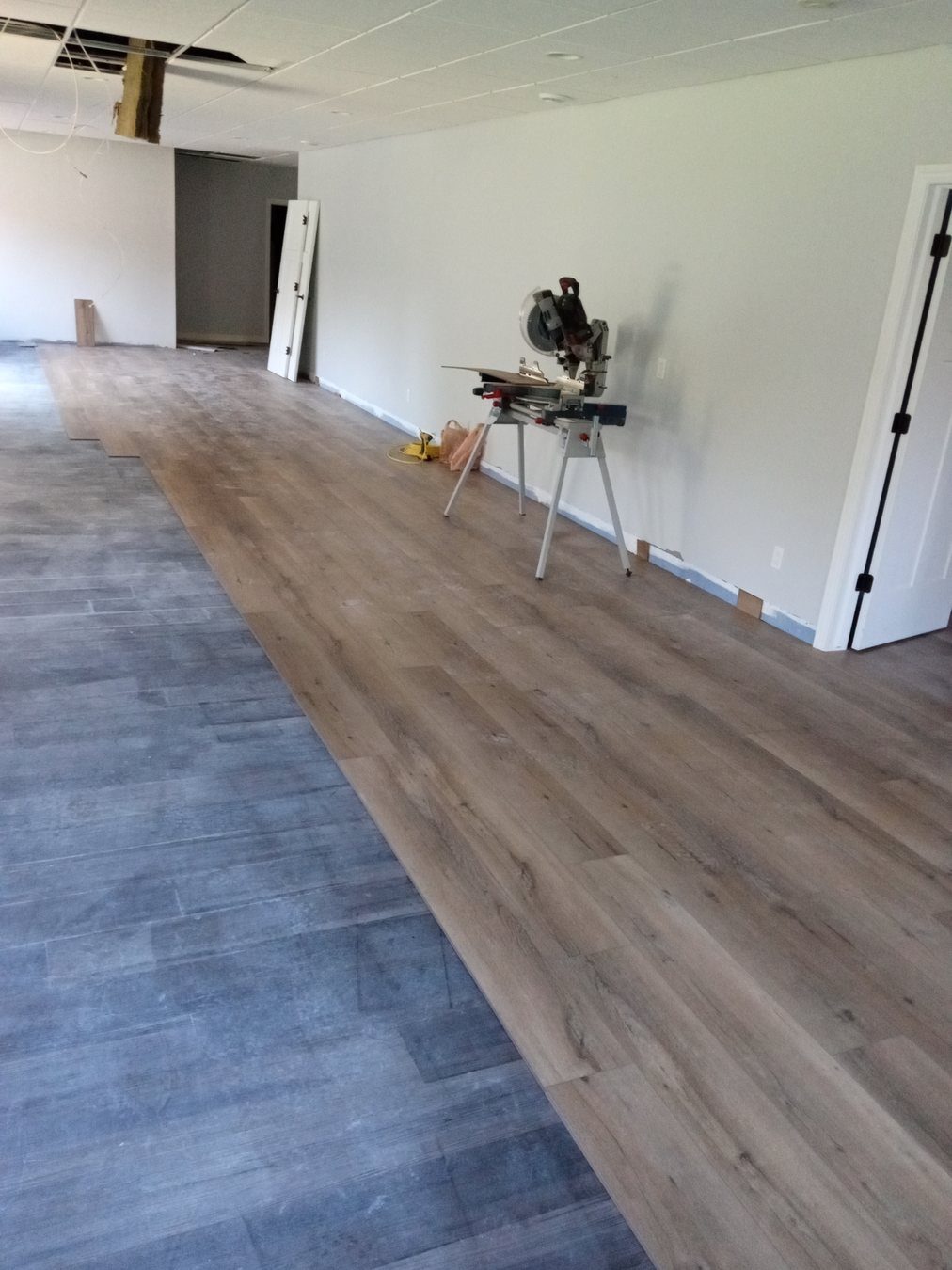 In-progress room showing protected floors during turnover work.
