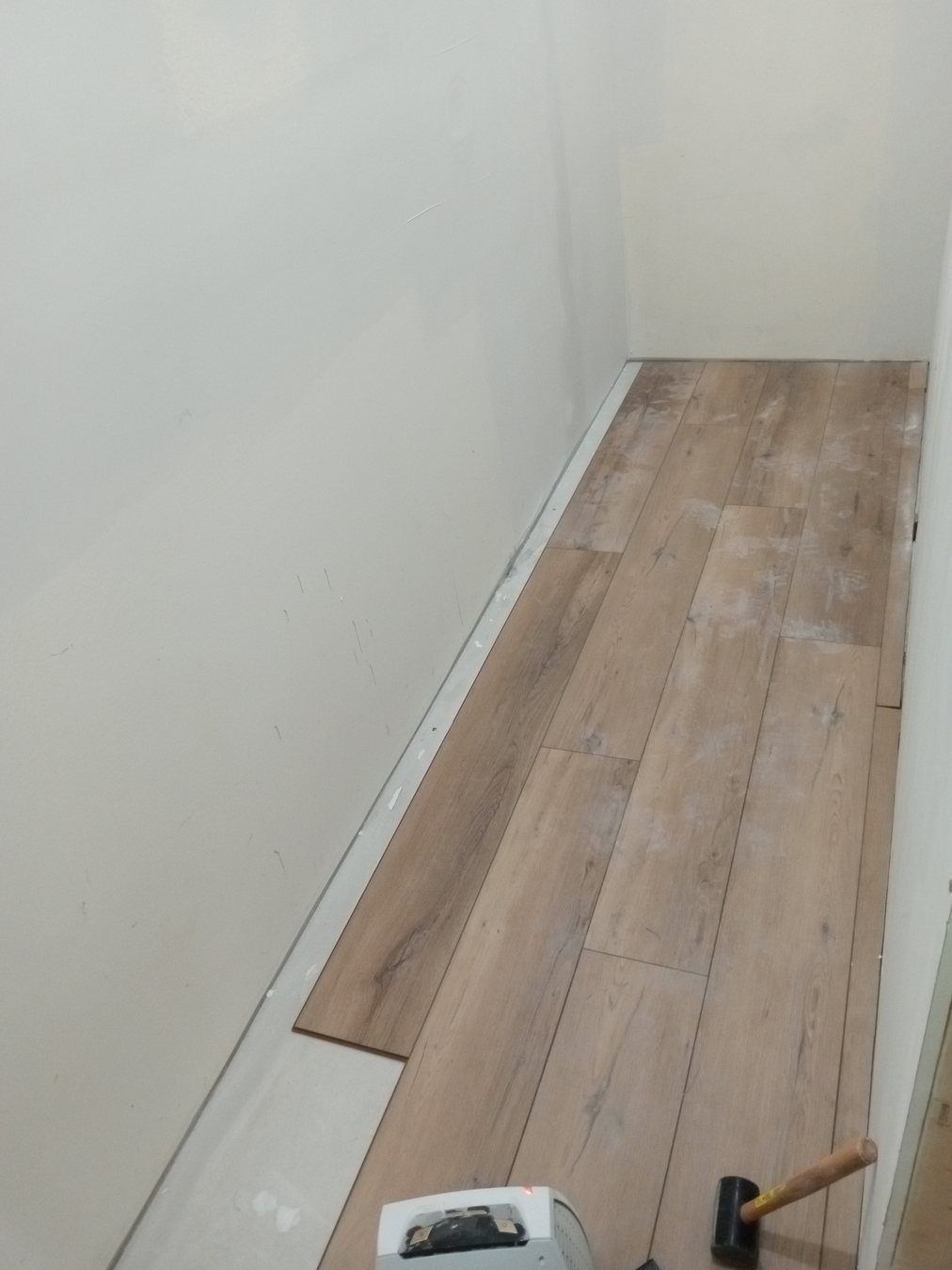 Fresh trim and flooring detail at a room edge.