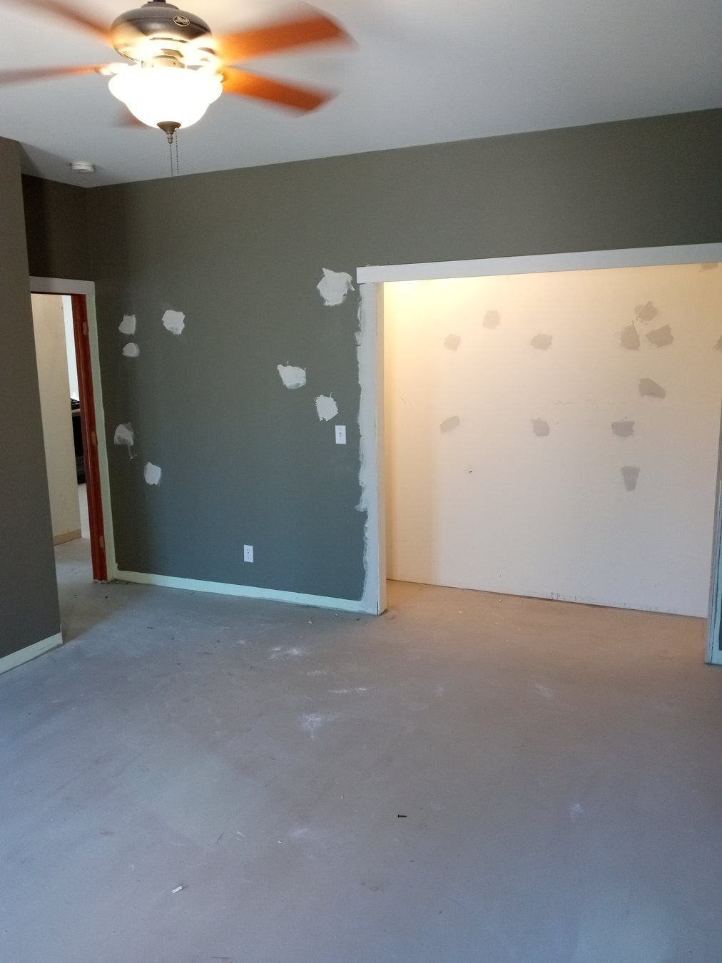 Room prepared for paint touch-ups and wall repair.